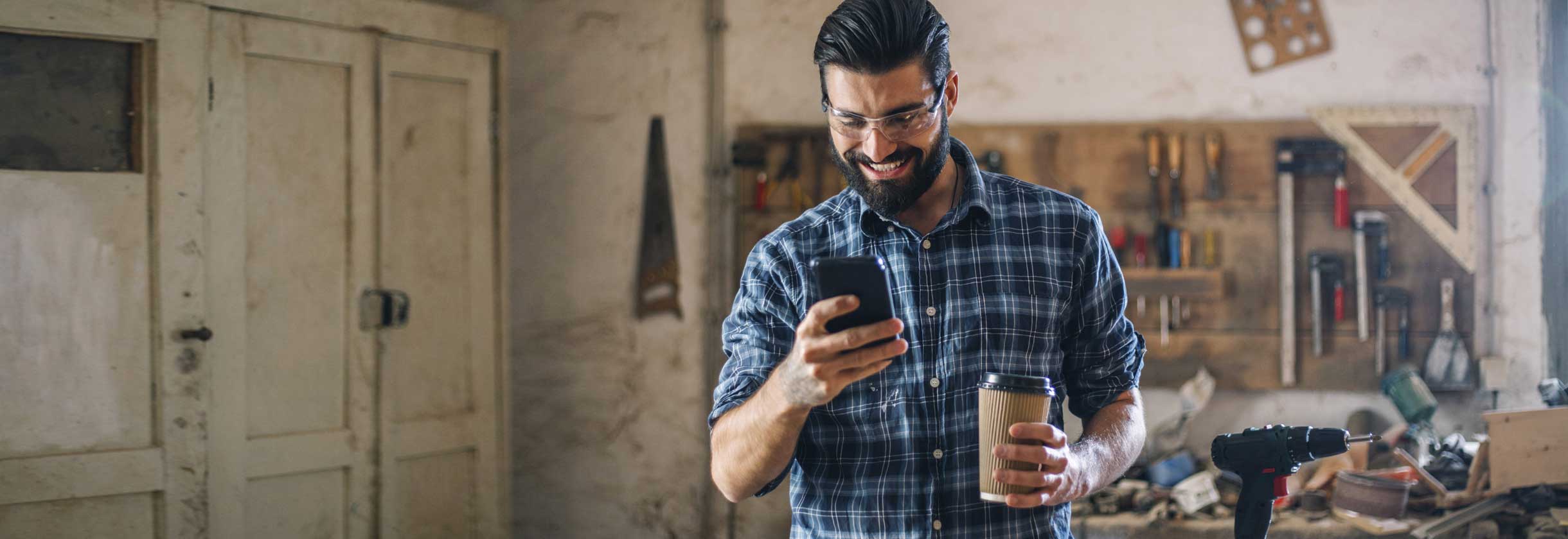 Construction worker using phone for estatement